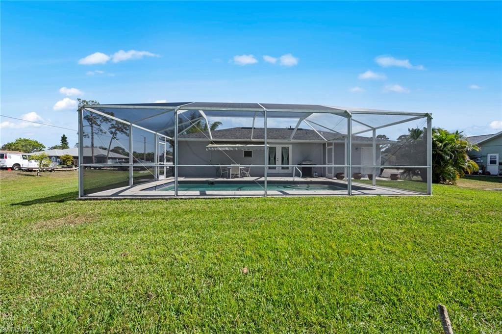 17528 Fuchsia Road Fort Myers, FL 33967 - Photo 37 of 42 a view of a big yard next to a house