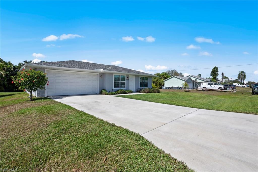 17528 Fuchsia Road Fort Myers, FL 33967 - Photo 40 of 42 a front view of house with yard and green space