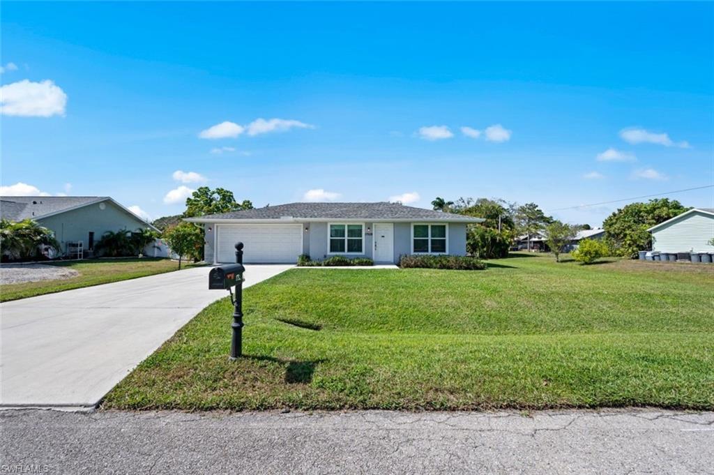 17528 Fuchsia Road Fort Myers, FL 33967 - Photo 7 of 42 a front view of a house with a yard