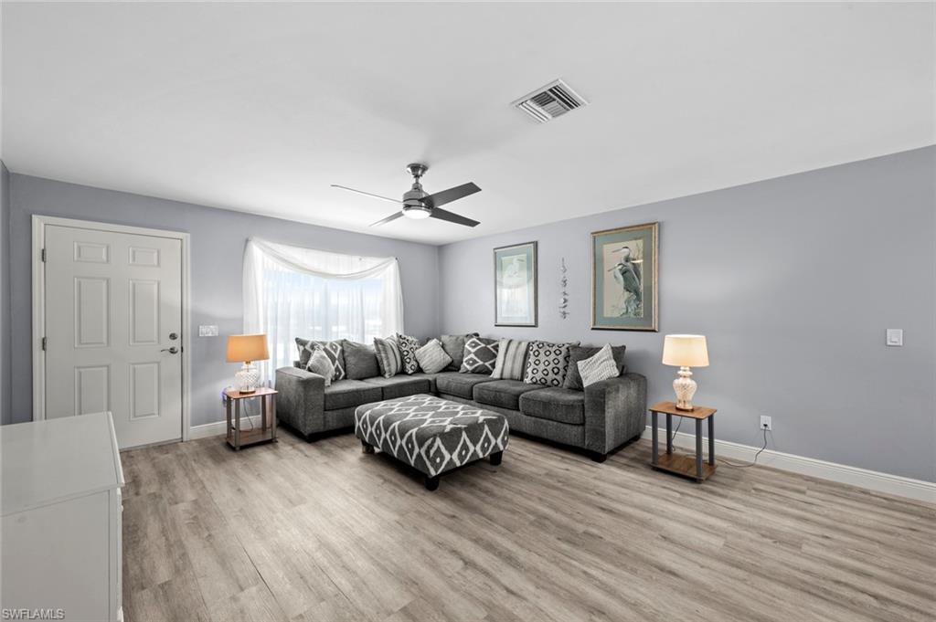 17528 Fuchsia Road Fort Myers, FL 33967 - Photo 10 of 42 a living room with furniture and a wooden floor