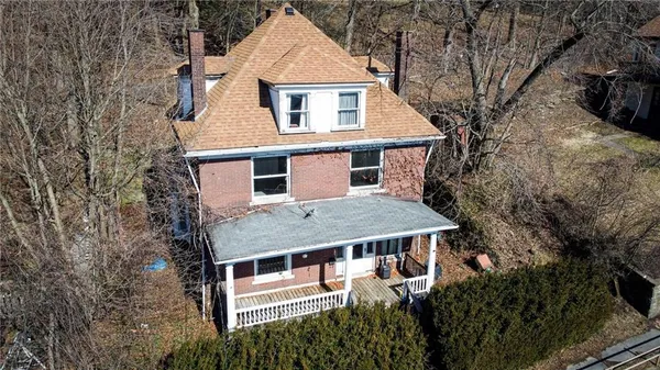 a aerial view of a house with a yard