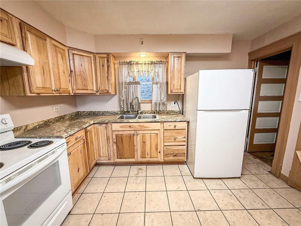 248 East Fulton Street Butler, PA 16001 - Photo 12 of 35 a kitchen with a stove a refrigerator and a sink