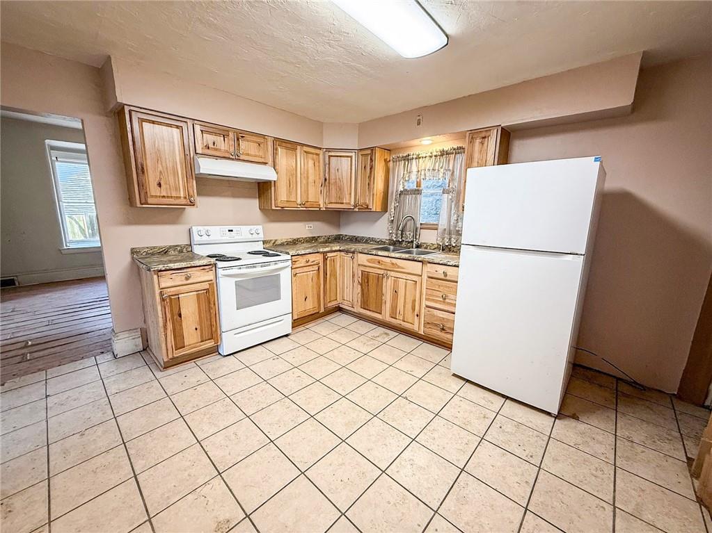 248 East Fulton Street Butler, PA 16001 - Photo 13 of 35 a kitchen with cabinets and steel stainless steel appliances