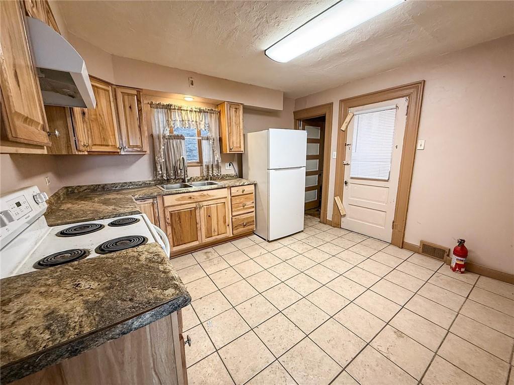 248 East Fulton Street Butler, PA 16001 - Photo 14 of 35 a kitchen with a refrigerator sink and stove