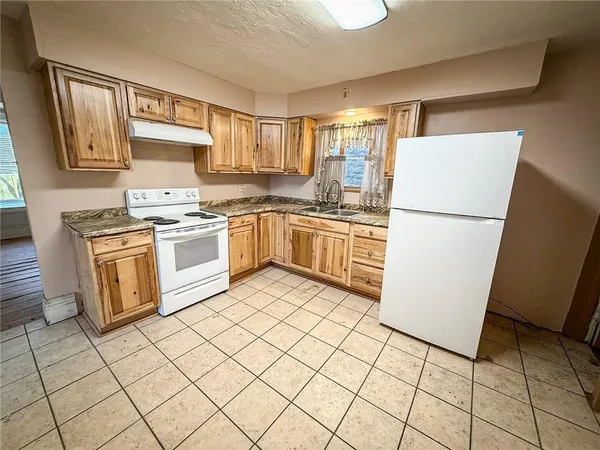 a kitchen with cabinets and white appliances