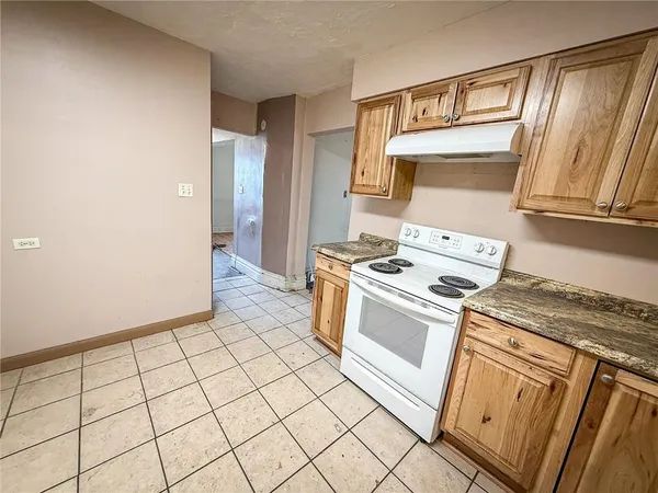 a kitchen with a stove top oven and sink