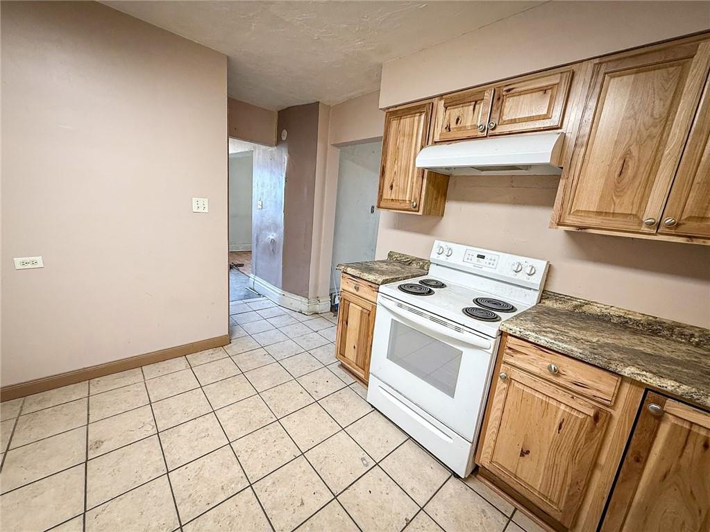 248 East Fulton Street Butler, PA 16001 - Photo 16 of 35 a kitchen with a stove top oven and sink