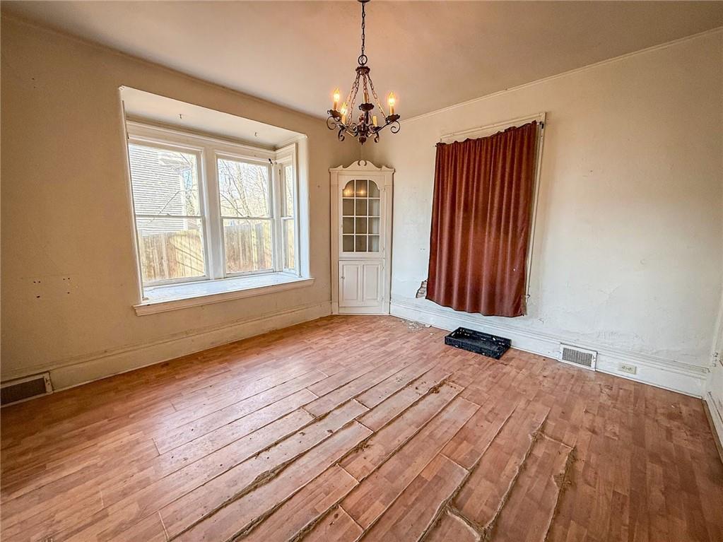 248 East Fulton Street Butler, PA 16001 - Photo 10 of 35 a view of an empty room with a window and wooden floor