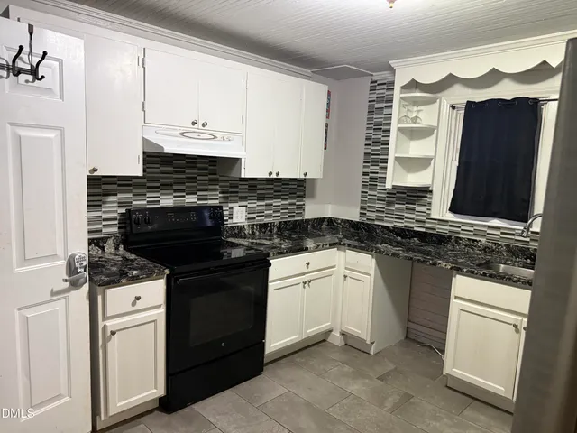 a kitchen with stainless steel appliances granite countertop a stove and a sink