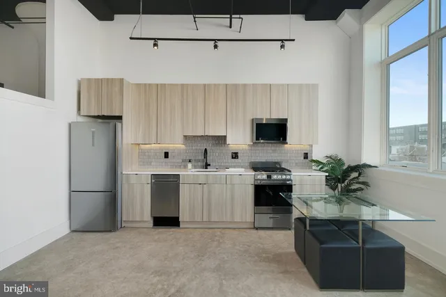 a kitchen with a sink stainless steel appliances and cabinets