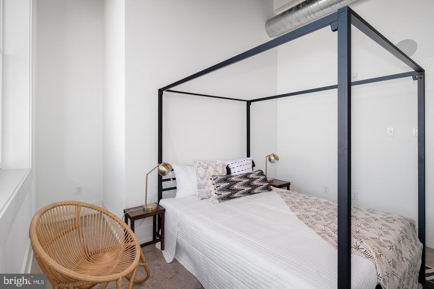 1218 Snyder Avenue, Unit 5 Philadelphia, PA 19148 - Photo 6 of 10 a bedroom with a bed a mirror and a window