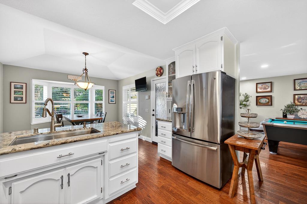 6610 Rio Oso Drive Rancho Murieta, CA 95683 - Photo 16 of 58 a kitchen with stainless steel appliances a refrigerator sink and wooden floor
