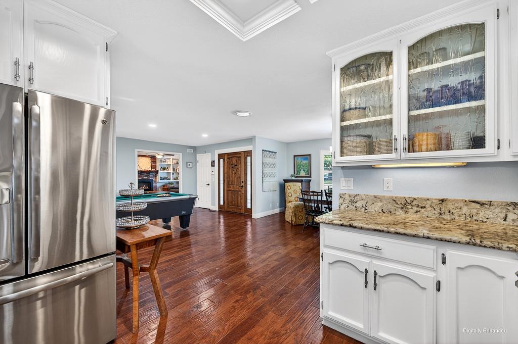6610 Rio Oso Drive Rancho Murieta, CA 95683 - Photo 17 of 58 a kitchen with a refrigerator and wooden floor