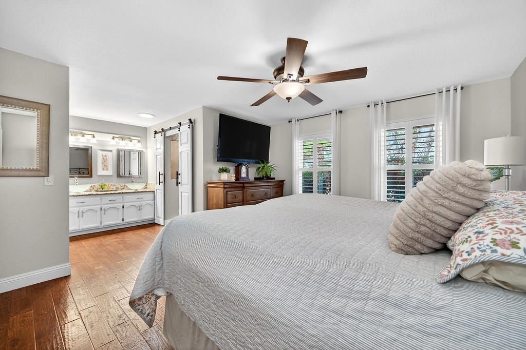 6610 Rio Oso Drive Rancho Murieta, CA 95683 - Photo 32 of 58 a bedroom with a large bed and a flat tv screen