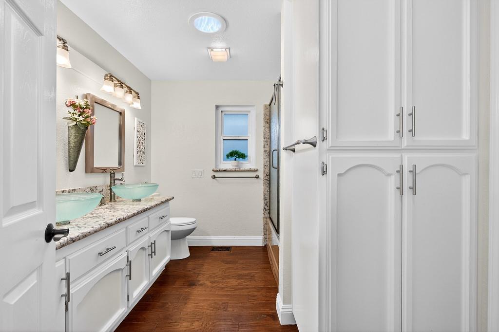6610 Rio Oso Drive Rancho Murieta, CA 95683 - Photo 41 of 58 a bathroom with a double vanity sink and mirror with shower