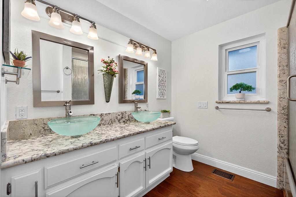 6610 Rio Oso Drive Rancho Murieta, CA 95683 - Photo 42 of 58 a bathroom with a granite countertop sink and a mirror