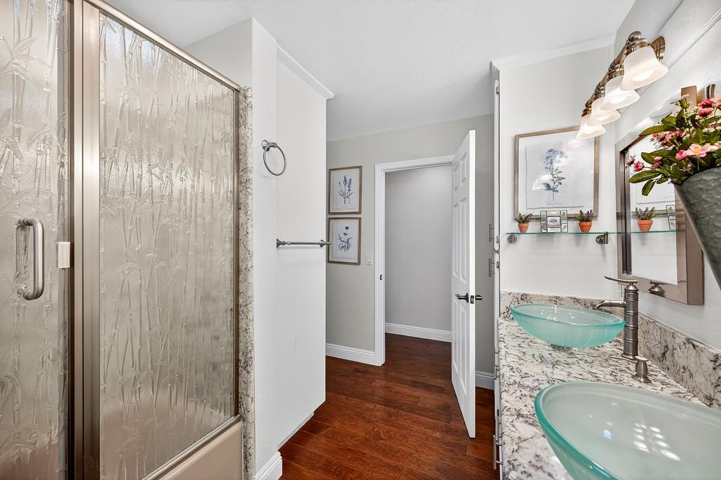 6610 Rio Oso Drive Rancho Murieta, CA 95683 - Photo 43 of 58 a bathroom with a granite countertop shower sink and mirror