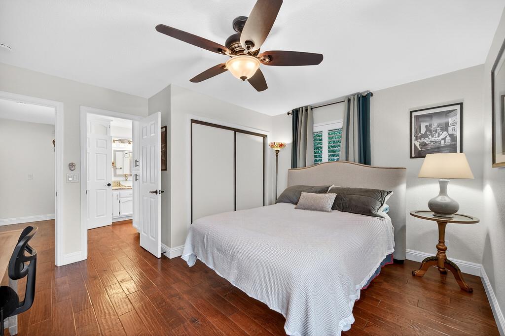 6610 Rio Oso Drive Rancho Murieta, CA 95683 - Photo 46 of 58 a bedroom with a bed and wooden floor