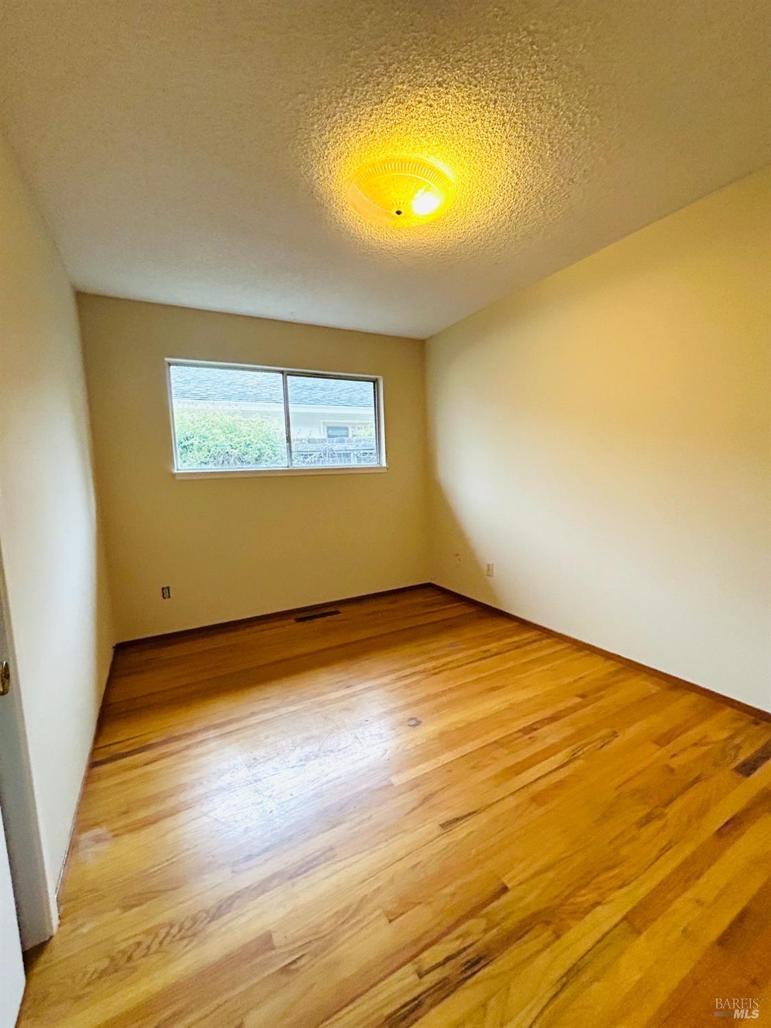 17884 Riverside Drive Sonoma, CA 95476 - Photo 16 of 20 a view of empty room with wooden floor