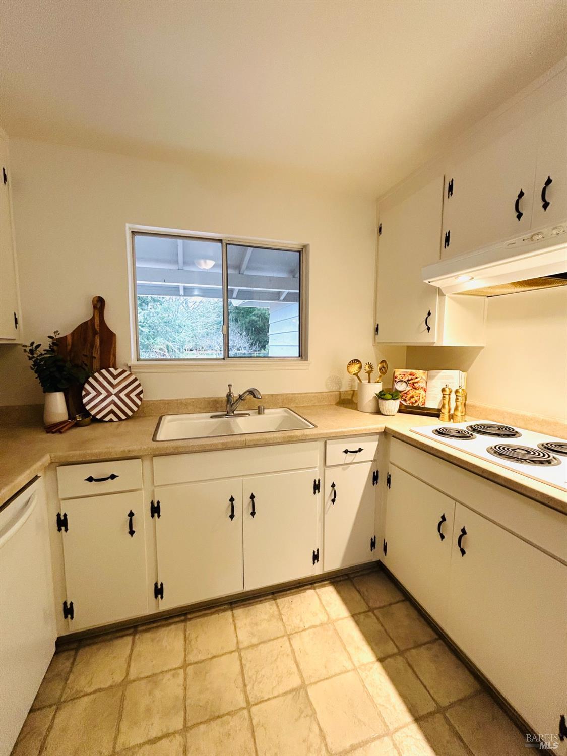 17884 Riverside Drive Sonoma, CA 95476 - Photo 6 of 20 a kitchen with granite countertop white cabinets and white appliances