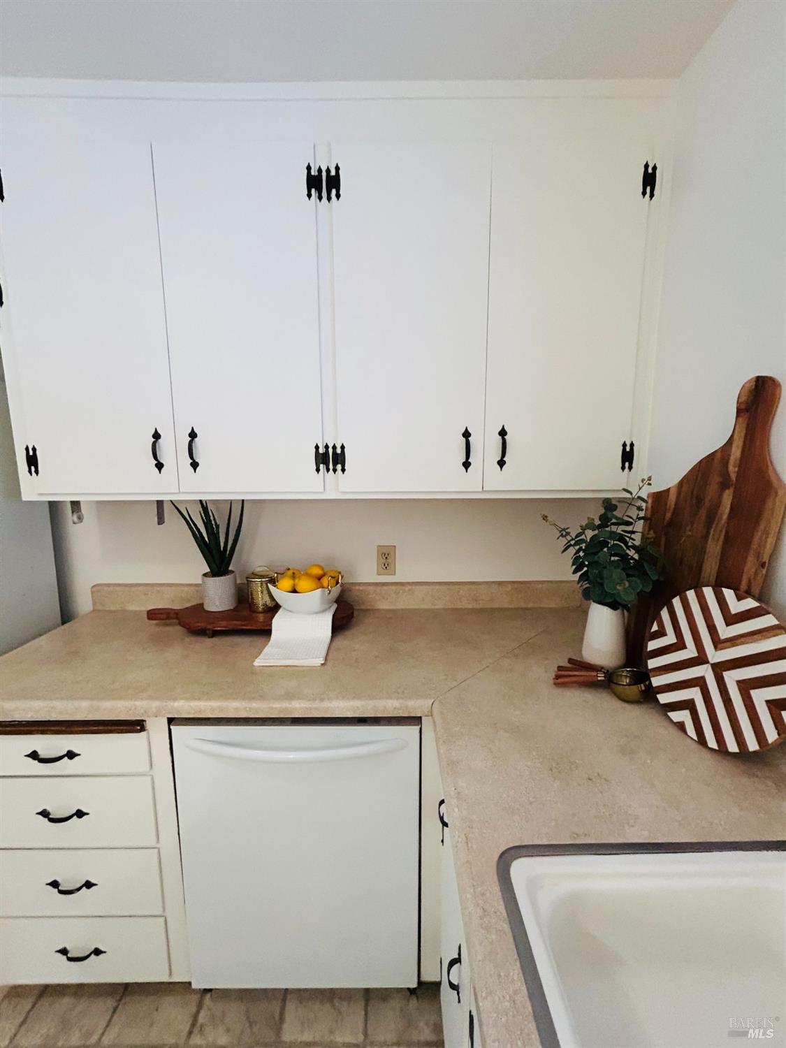 17884 Riverside Drive Sonoma, CA 95476 - Photo 7 of 20 a kitchen with white cabinets and sink
