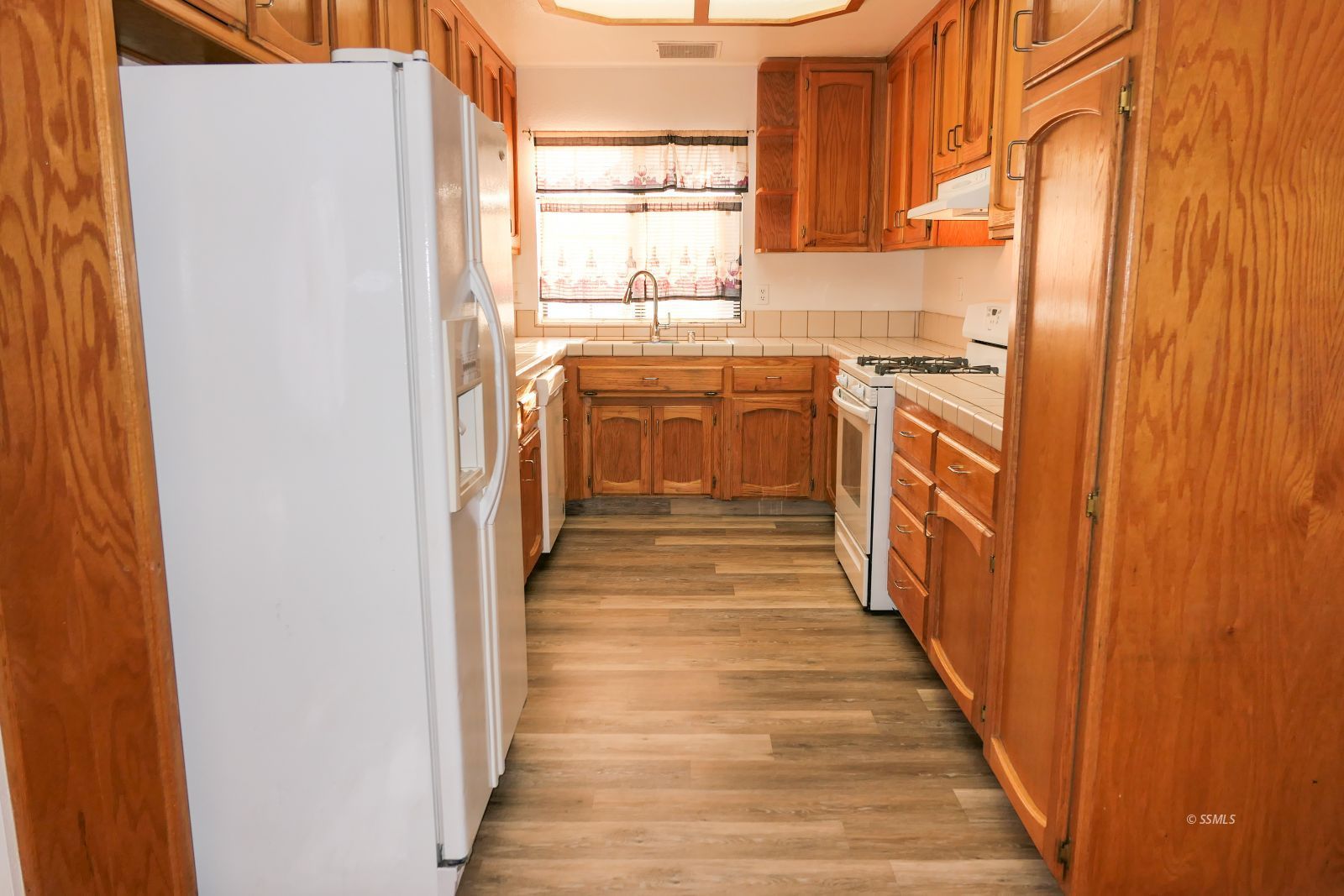 322 Reese Street Ridgecrest, CA 93555 - Photo 8 of 35 a kitchen with stainless steel appliances granite countertop a refrigerator and a sink