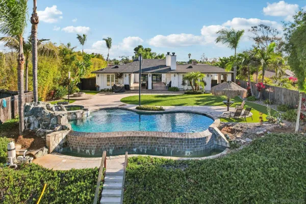 an aerial view of a house with swimming pool garden and patio