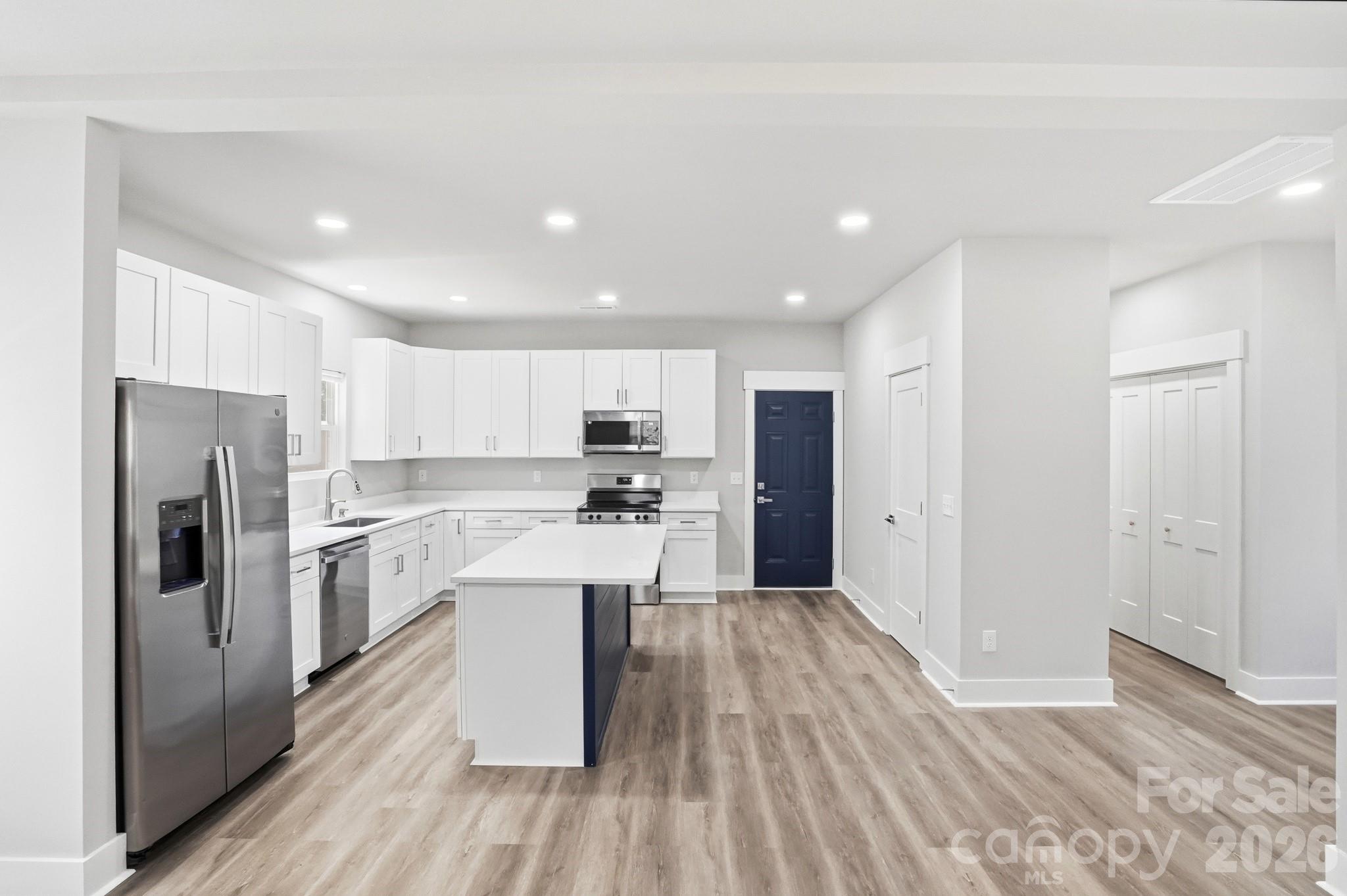 208 Wylie Park Road Lancaster, SC 29720 - Photo 13 of 48 a kitchen with refrigerator cabinets and wooden floor