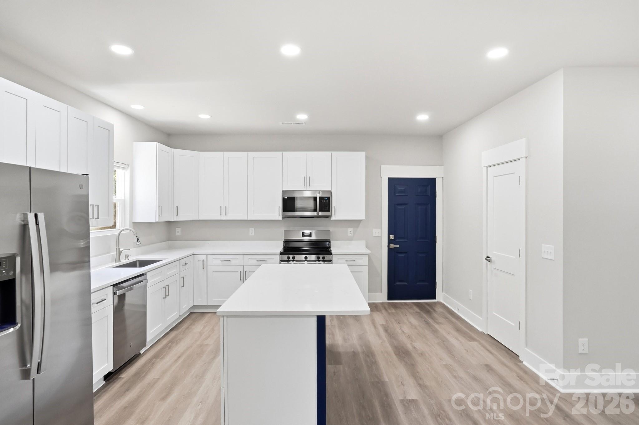 208 Wylie Park Road Lancaster, SC 29720 - Photo 14 of 48 a kitchen with a refrigerator a sink and cabinets