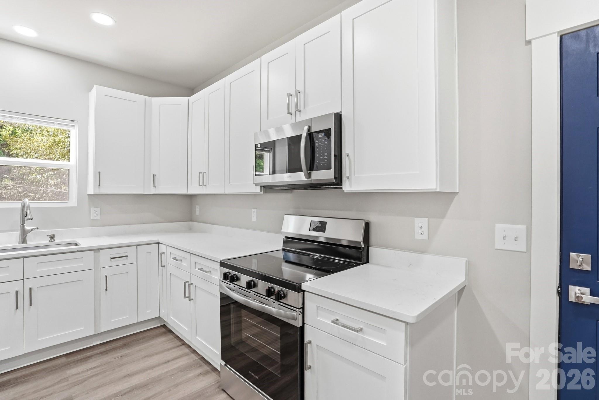 208 Wylie Park Road Lancaster, SC 29720 - Photo 17 of 48 a kitchen with cabinets appliances a sink and a window