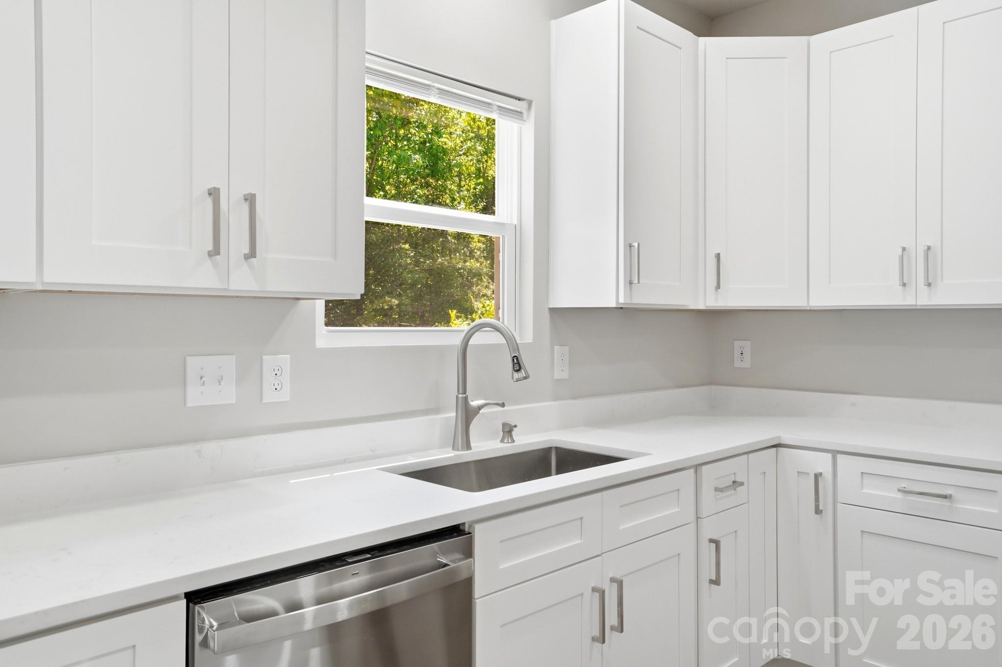 208 Wylie Park Road Lancaster, SC 29720 - Photo 19 of 48 a kitchen with white cabinets and a sink