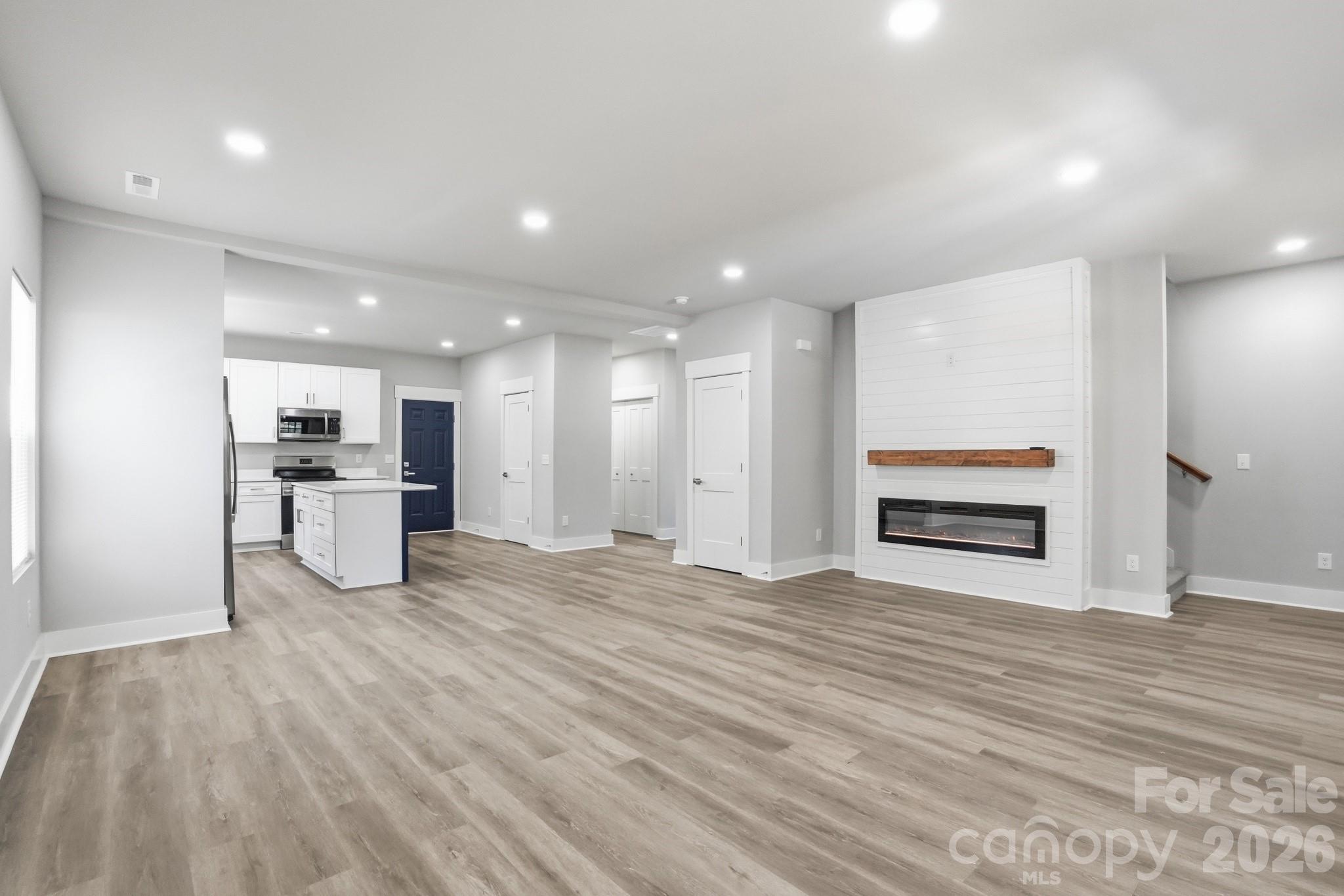 208 Wylie Park Road Lancaster, SC 29720 - Photo 6 of 48 a view of an empty room with wooden floor kitchen and a window