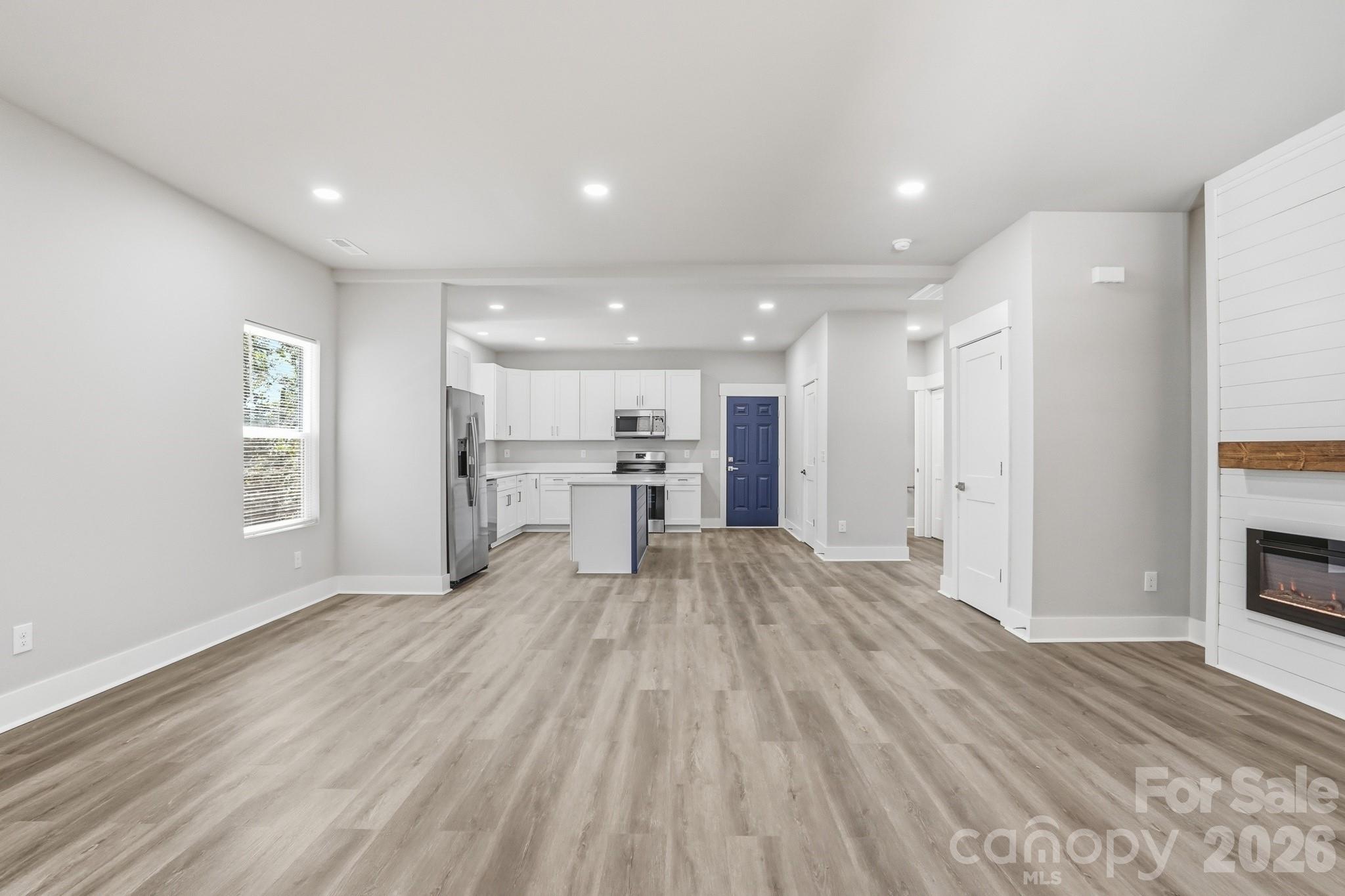 208 Wylie Park Road Lancaster, SC 29720 - Photo 7 of 48 a view of kitchen with wooden floor and windows