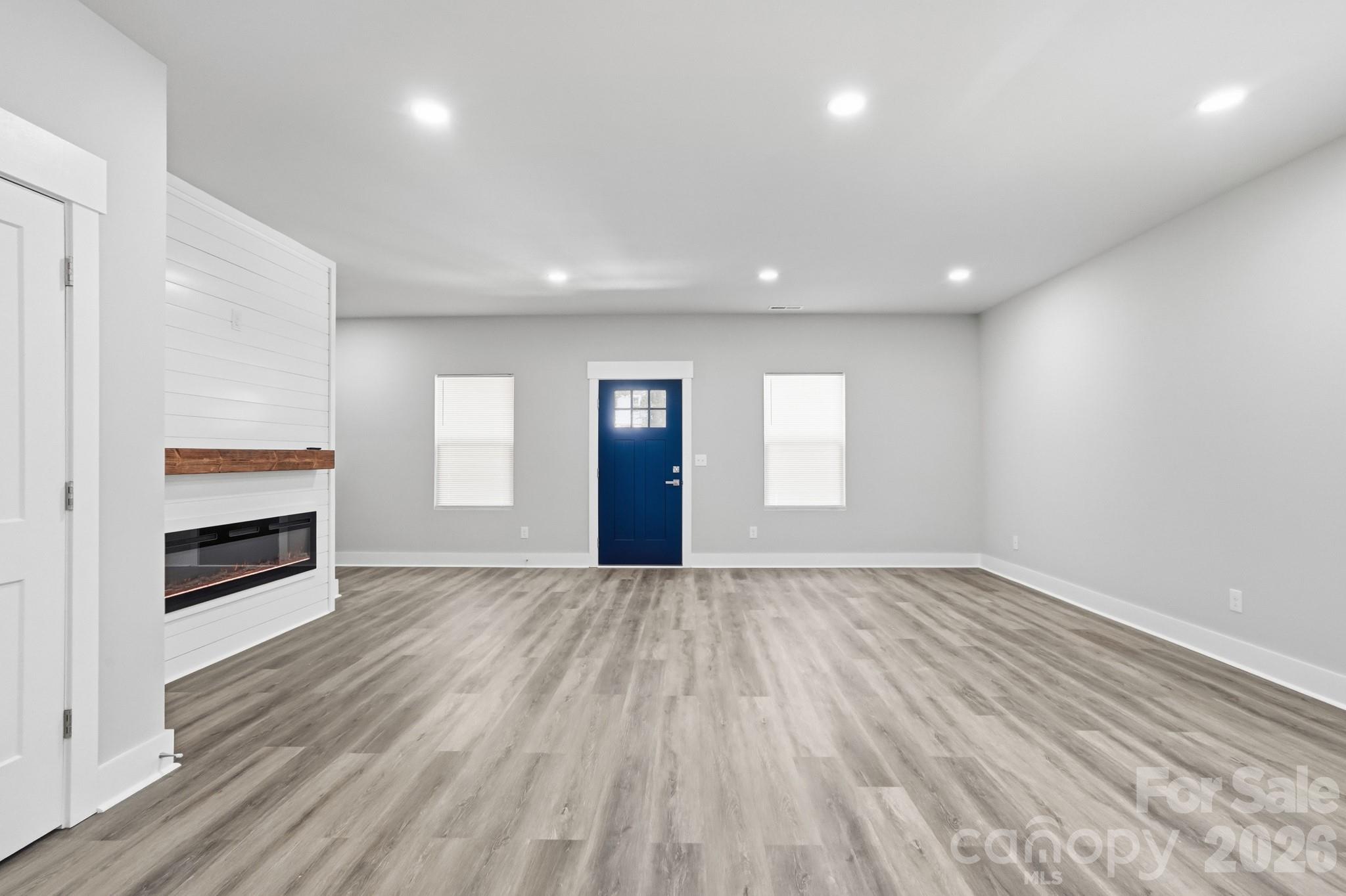 208 Wylie Park Road Lancaster, SC 29720 - Photo 9 of 48 an empty room with wooden floor and fireplace