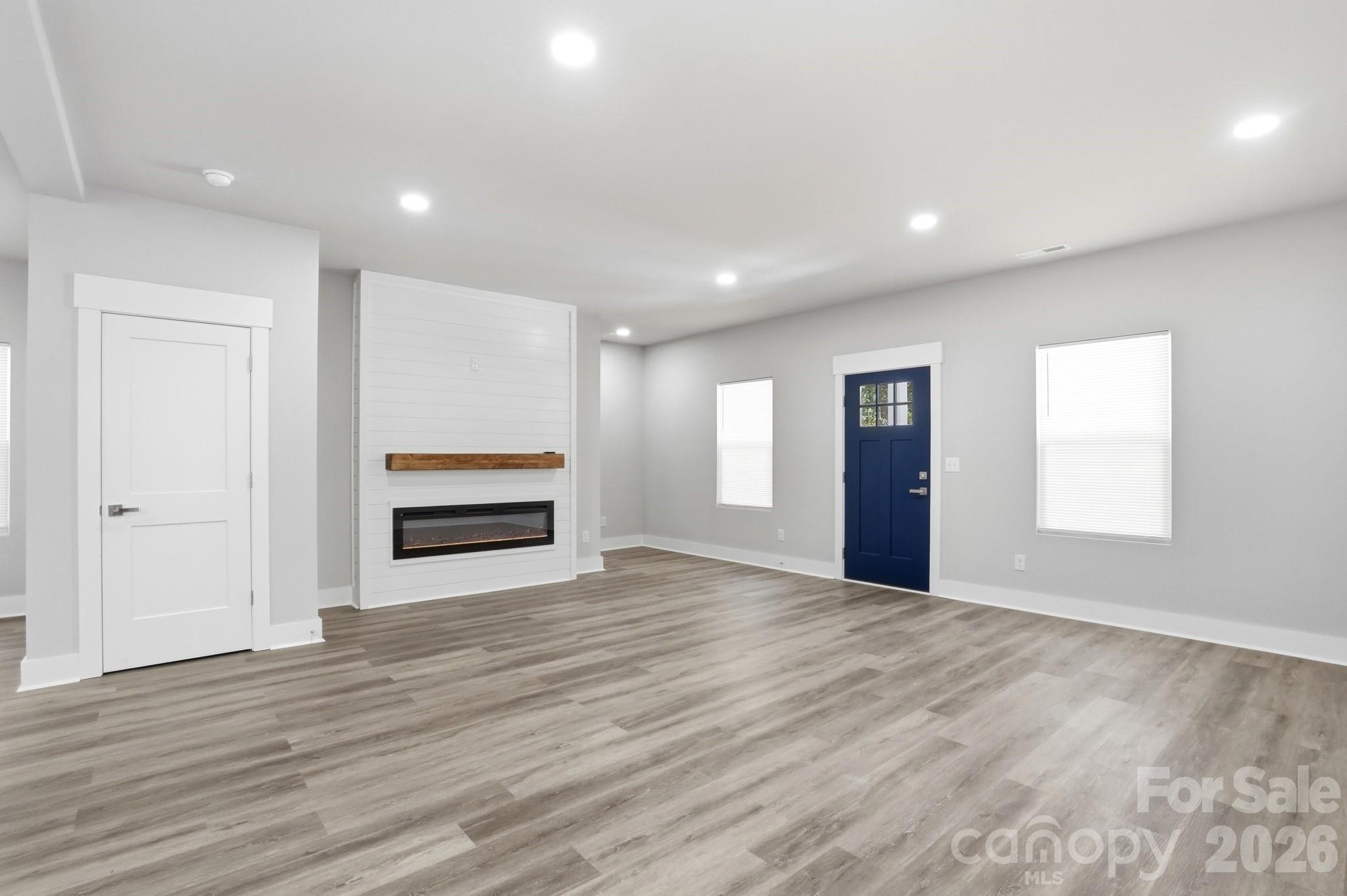 208 Wylie Park Road Lancaster, SC 29720 - Photo 10 of 48 a view of empty room with wooden floor and fireplace