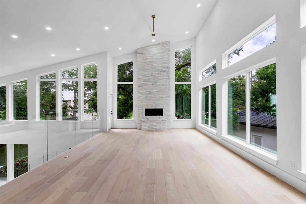 13032 Copenhill Road Dallas, TX 75240 - Photo 24 of 40 a view of a big room with large windows and a fireplace