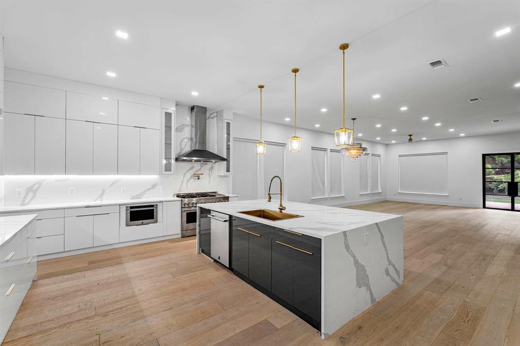 13032 Copenhill Road Dallas, TX 75240 - Photo 4 of 40 a kitchen with stainless steel appliances granite countertop a sink a stove and a refrigerator