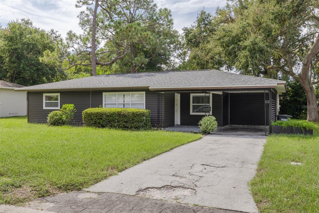 a front view of a house with a garden and porch