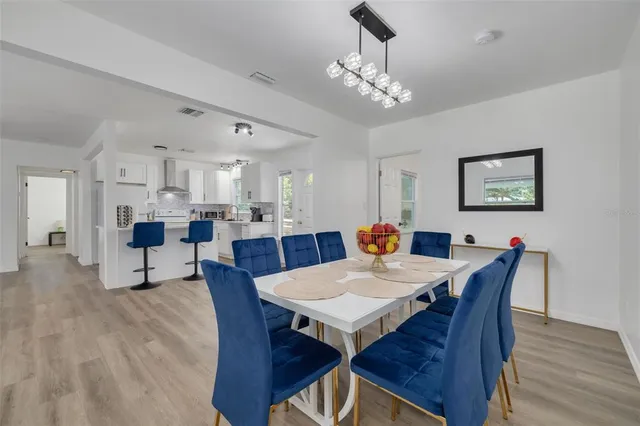 a view of a dining room with furniture and wooden floor