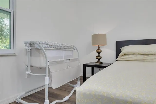 a bedroom with a bed and a lamp