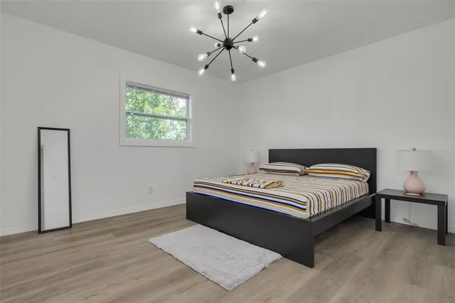 a bedroom with bed and a window