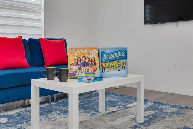a table with a couch and a wall painting