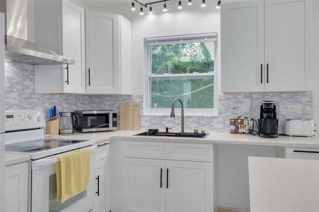 a kitchen with a sink cabinets and window