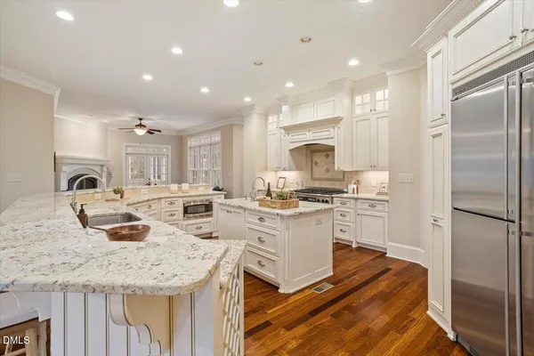 a bathroom with a granite countertop sink a toilet and a mirror