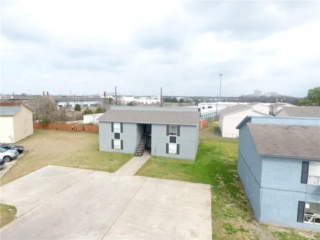 a view of a terrace with lawn chairs