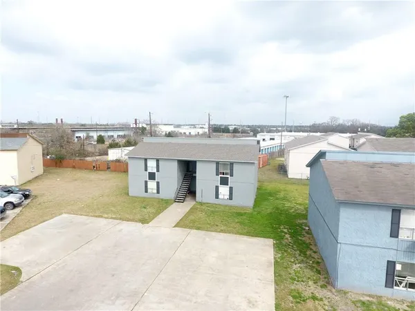 a view of a terrace with lawn chairs