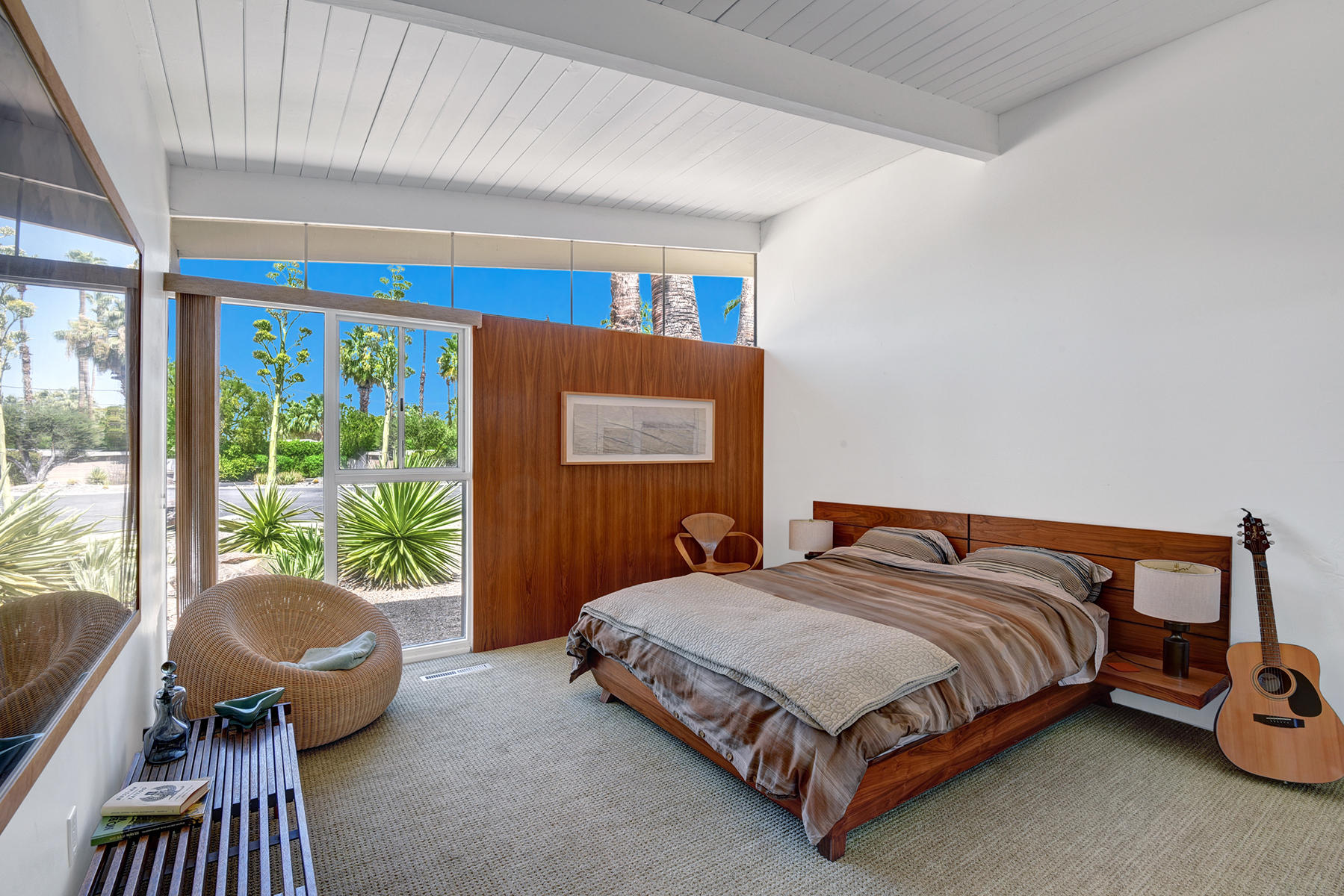 1865 Apache Circle Palm Springs, CA 92264 - Photo 18 of 42 a bedroom with a bed and glass window