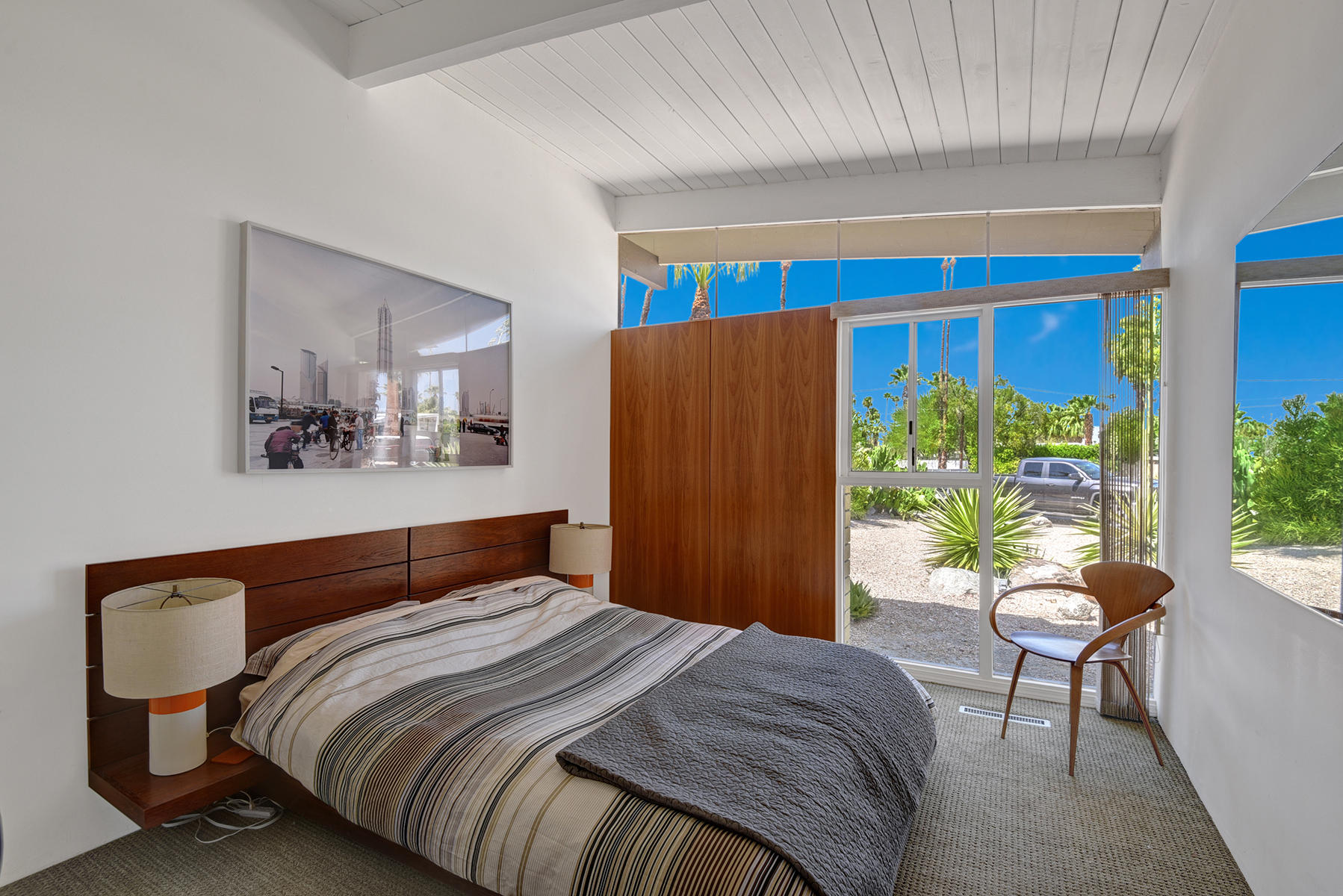 1865 Apache Circle Palm Springs, CA 92264 - Photo 20 of 42 a bedroom with a bed and potted plant