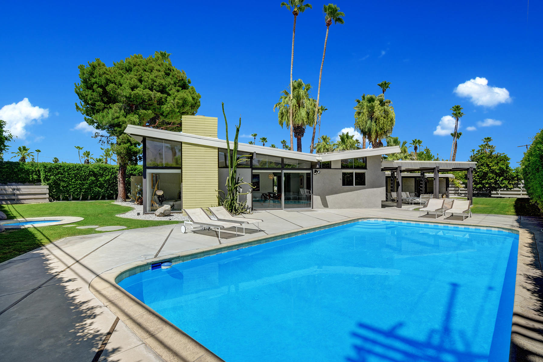 1865 Apache Circle Palm Springs, CA 92264 - Photo 30 of 42 a view of a house with pool and chairs