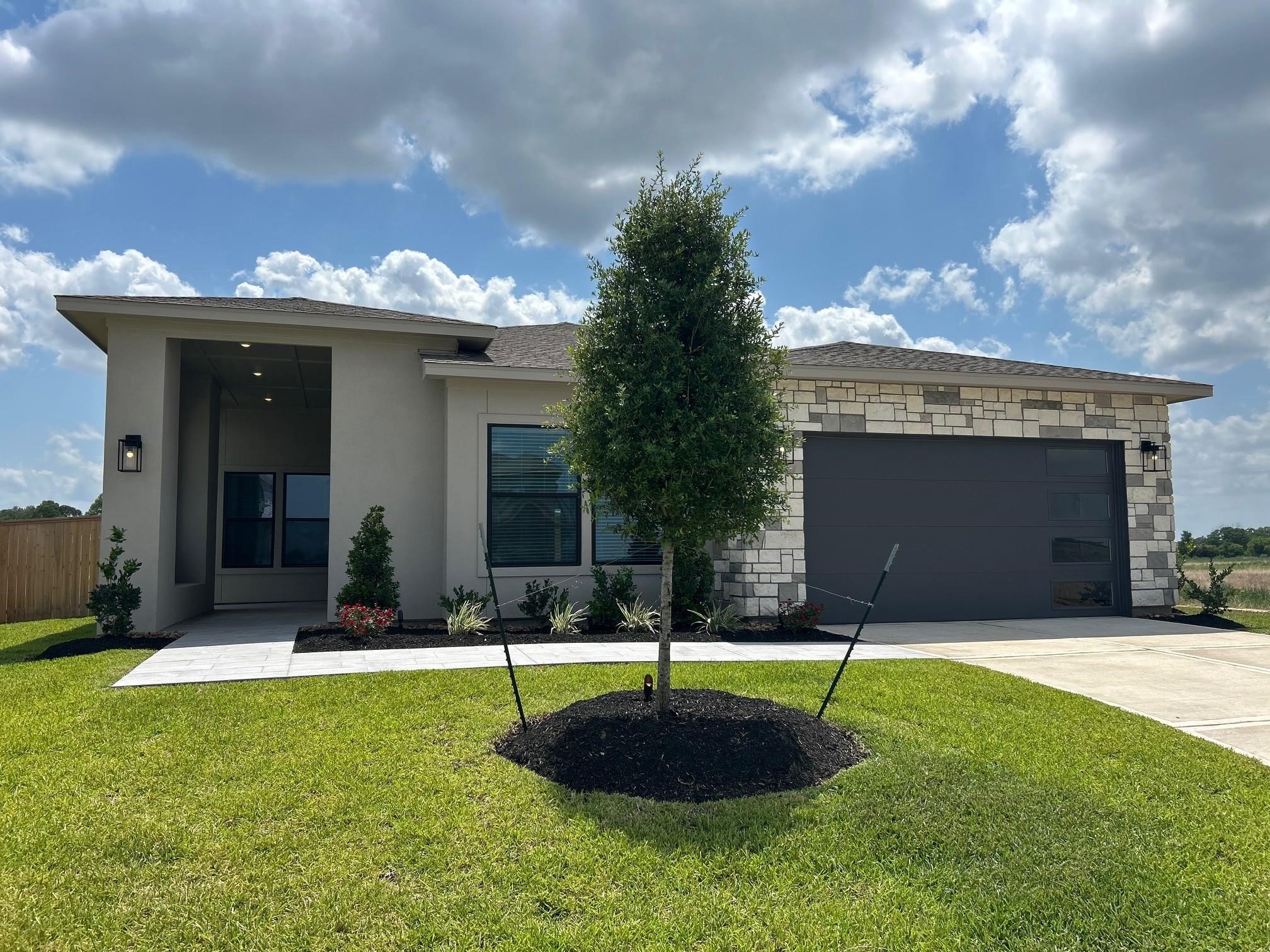 a view of a house with a yard and tree